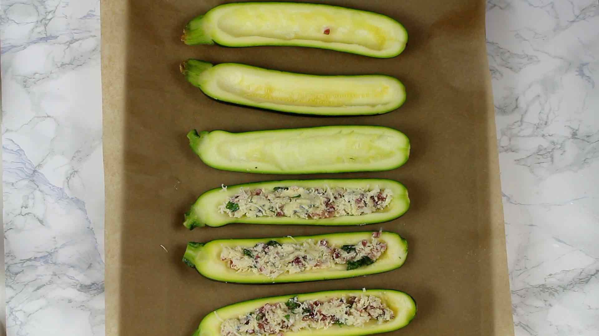 half Keto Bacon Zucchini Boats filled with cheese