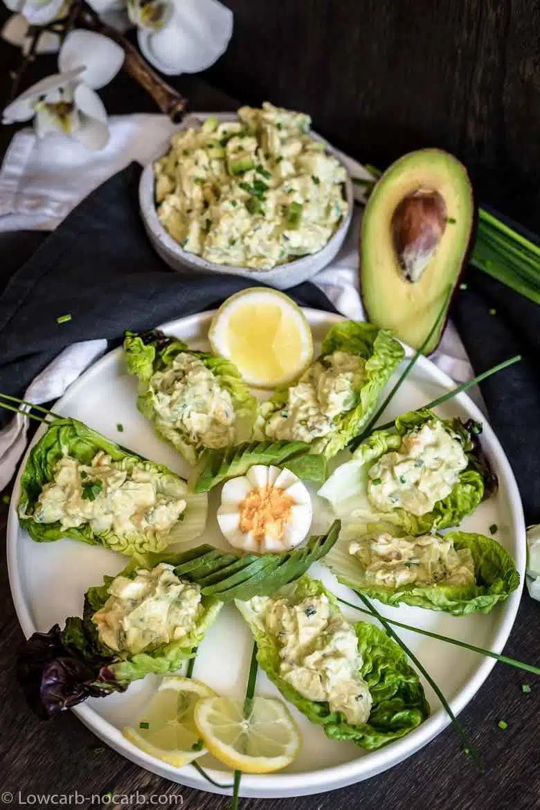 Avocado egg salad decorated on a big white plate