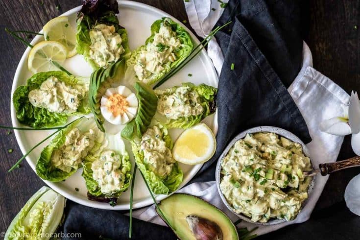 Avocado egg salad inside green leaves
