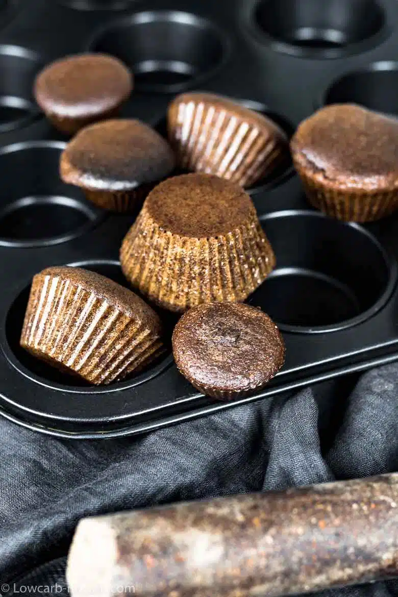 Chocolate Keto Cupcakes spread around baking muffin tint