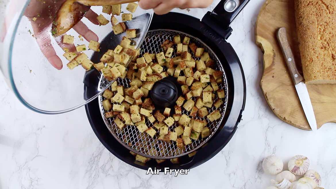 pouring croutons into the Air Fryer