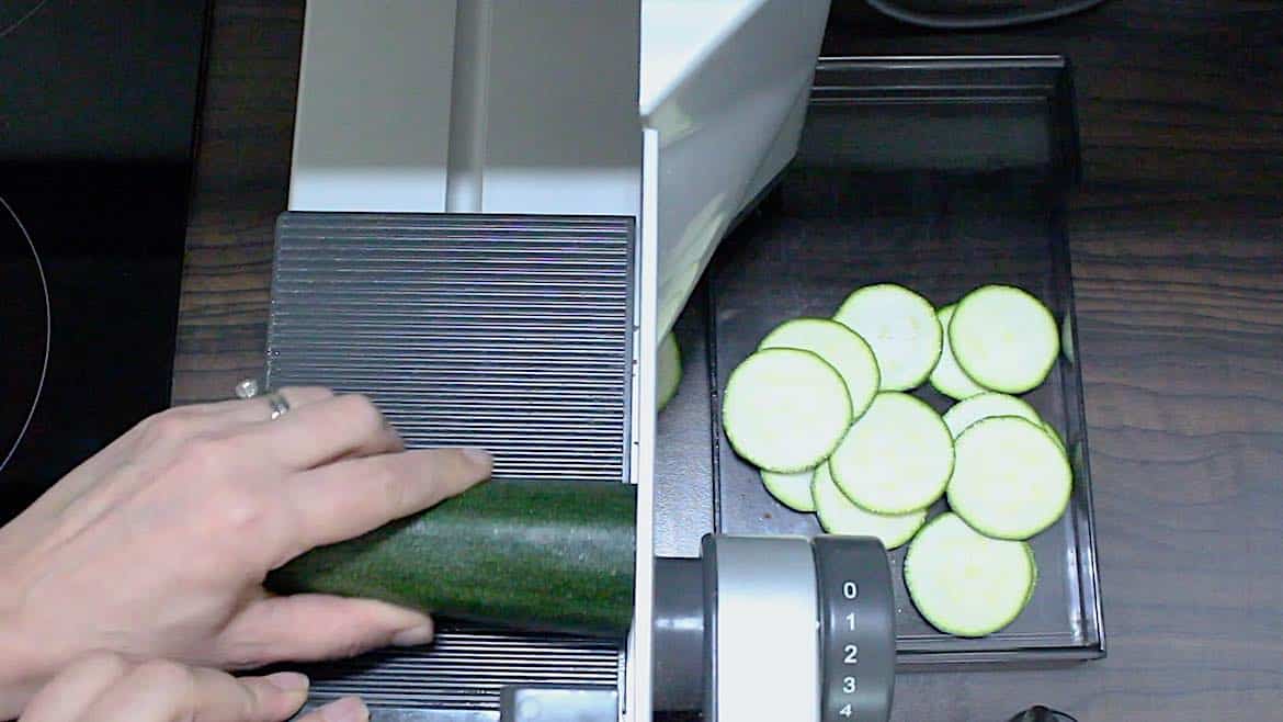 slicing zucchinis on a meat slicer maschine