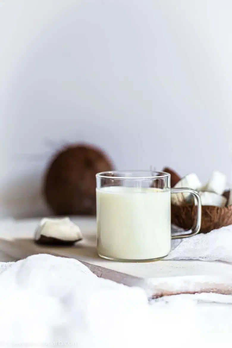 keto coconut milk in a glass with white background