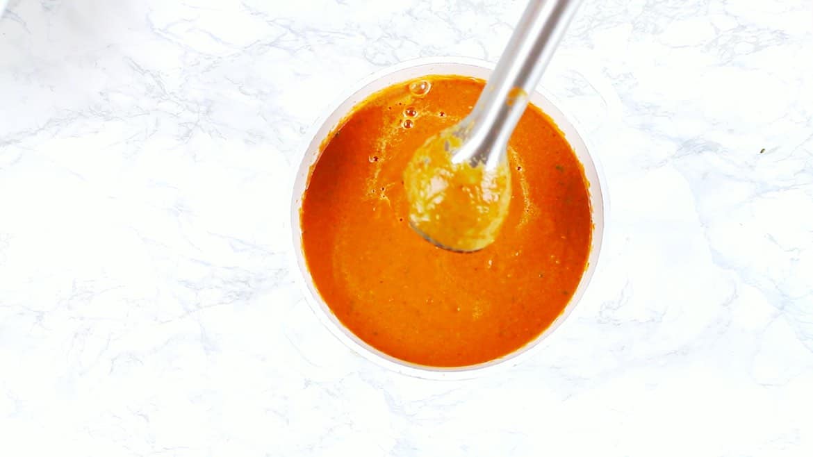 mixing low carb tomato soup with hand blender