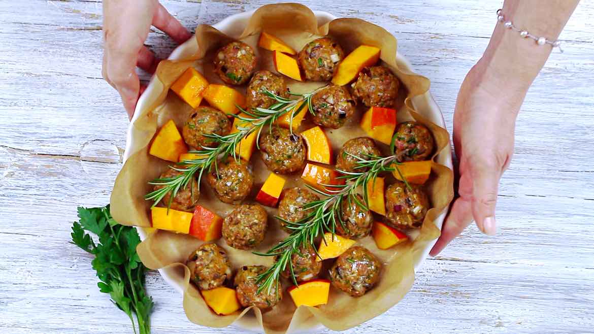 Placing the Keto Meatballs with Pumpkins for roasting