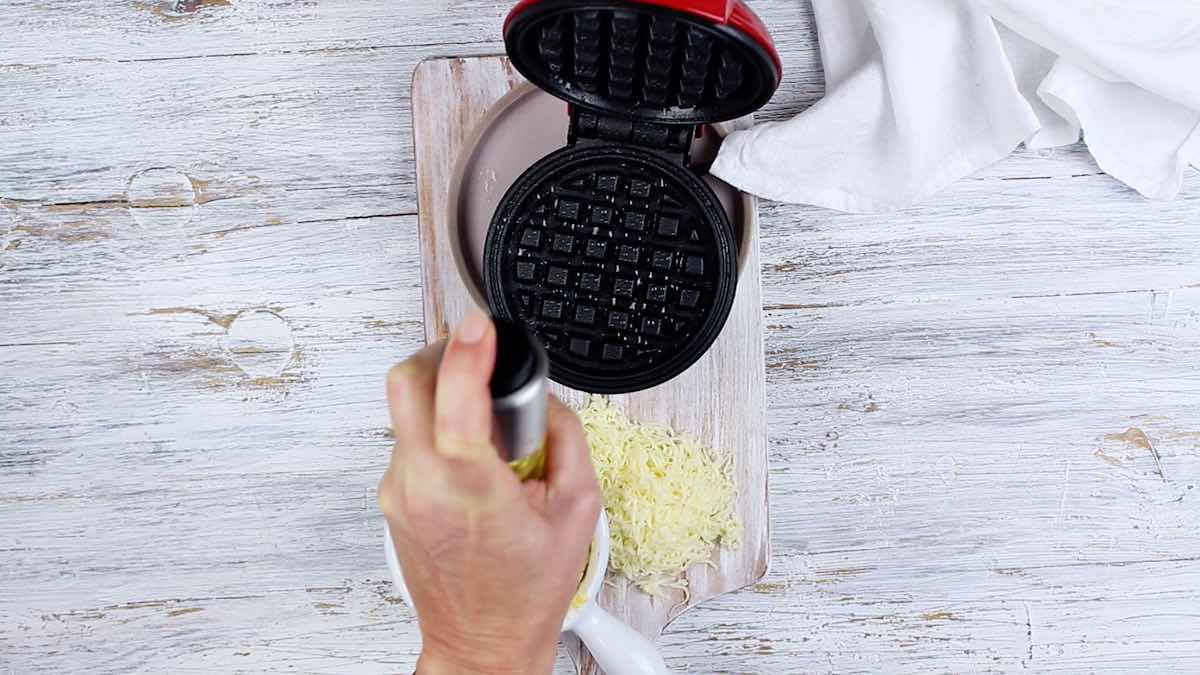 Amazing Chaffle Recipe spraying the waffle maker