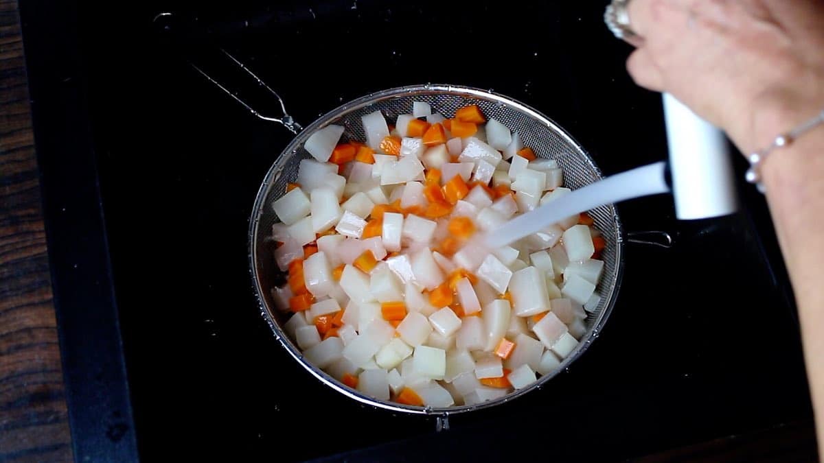 Poring cold water on Cooked Turnips and carrots