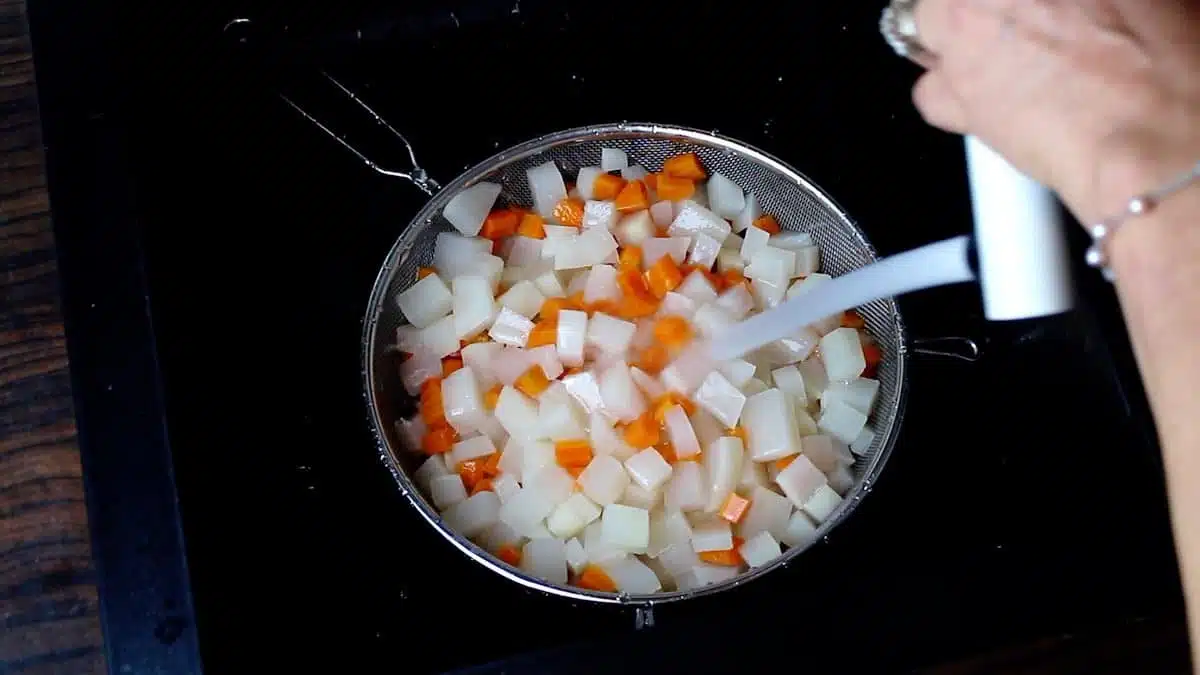 Poring cold water on Cooked Turnips and carrots