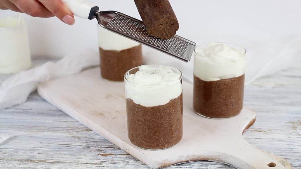 Chocolate Pudding Chia spreading cocoa on top