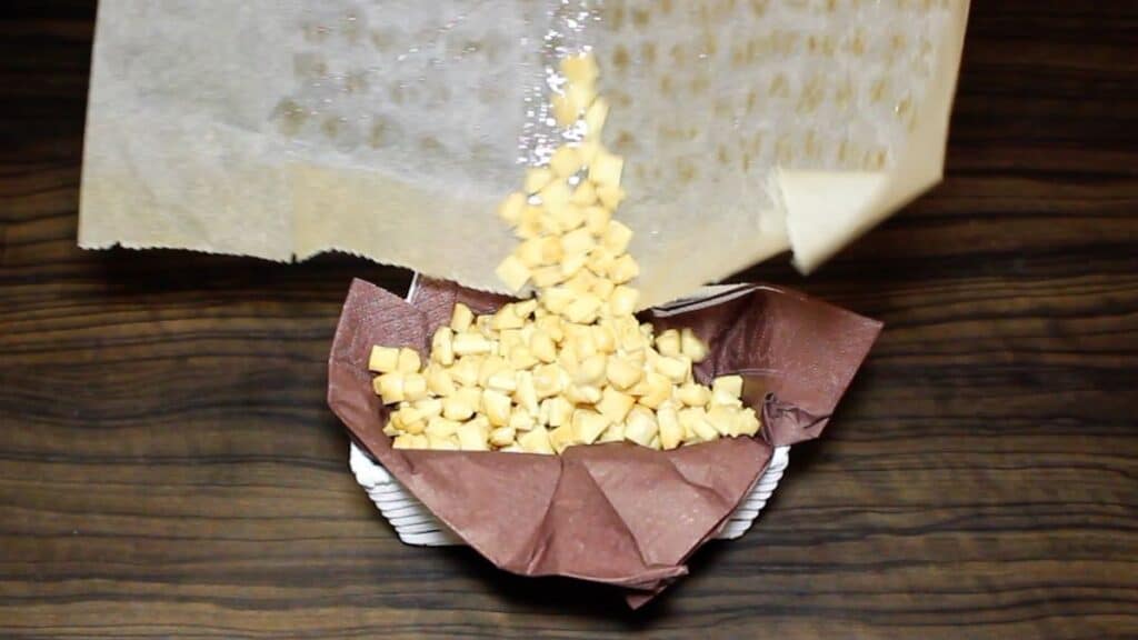 The Best Keto Popcorn Recipe being poured into the basket