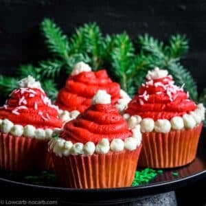 Keto Santa Cupcakes on a plate with green brunch behind