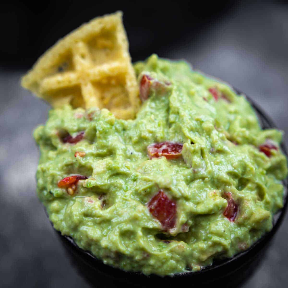 Keto Guacamole Dip Recipe close up with a Keto Snack dipped in