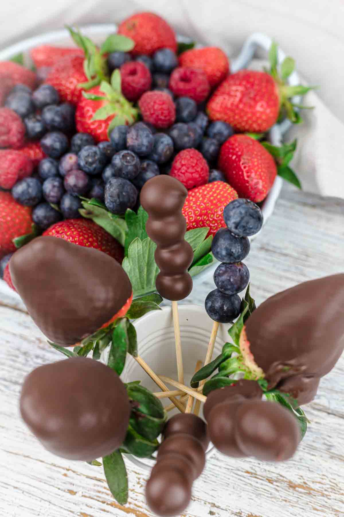 Recipe For Chocolate Covered Strawberries on a wooden stick on a jar