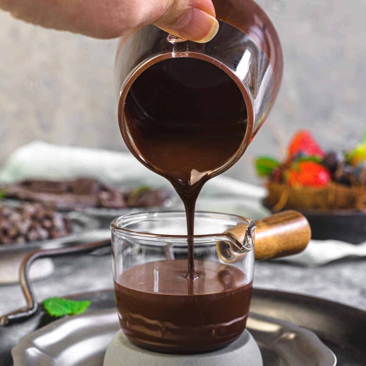 Sugar-Free Chocolate Magic Shell Recipe pouring melted chocolate into a glass cup