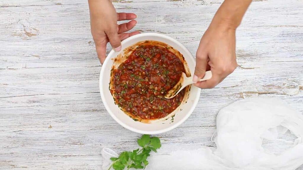 Low Carb Salsa mixing all ingredients together