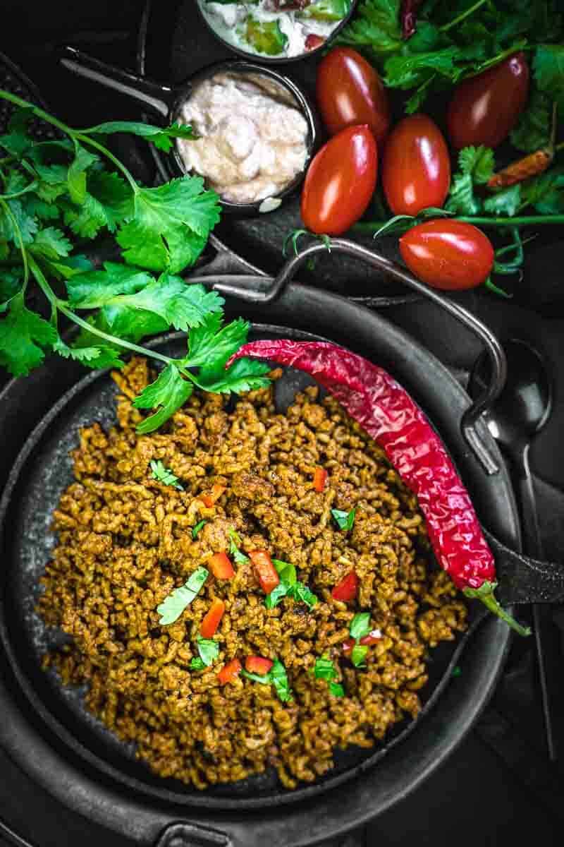 taco meat recipe with chilli on a black plate
