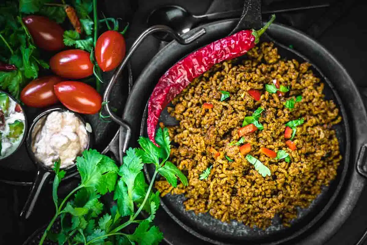 taco meat recipe with chilli on a black plate