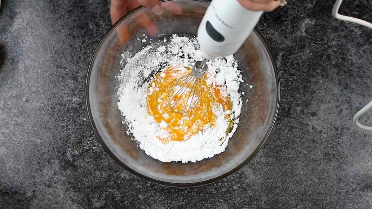 Sugar-Free Homemade Eggnog Recipe whisking egg yolks together with sweetener.