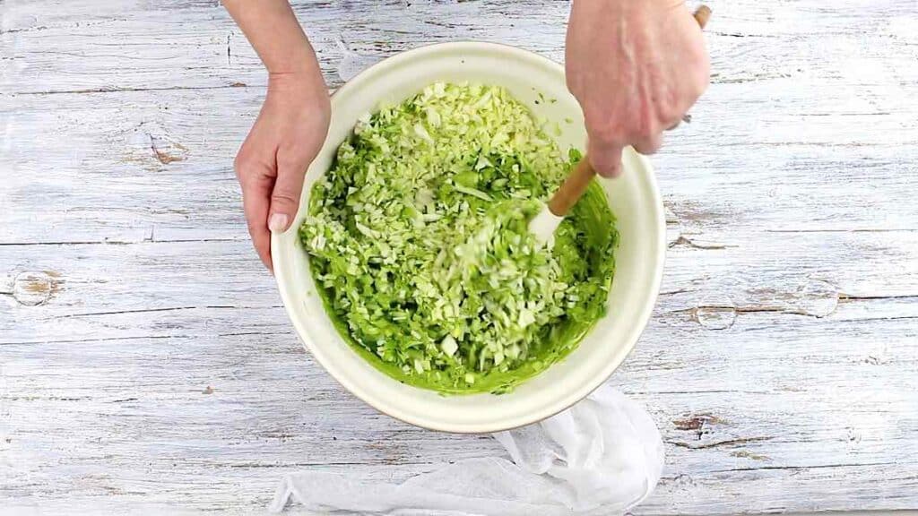 Green Goddess Salad Recipe mixing dressing into.