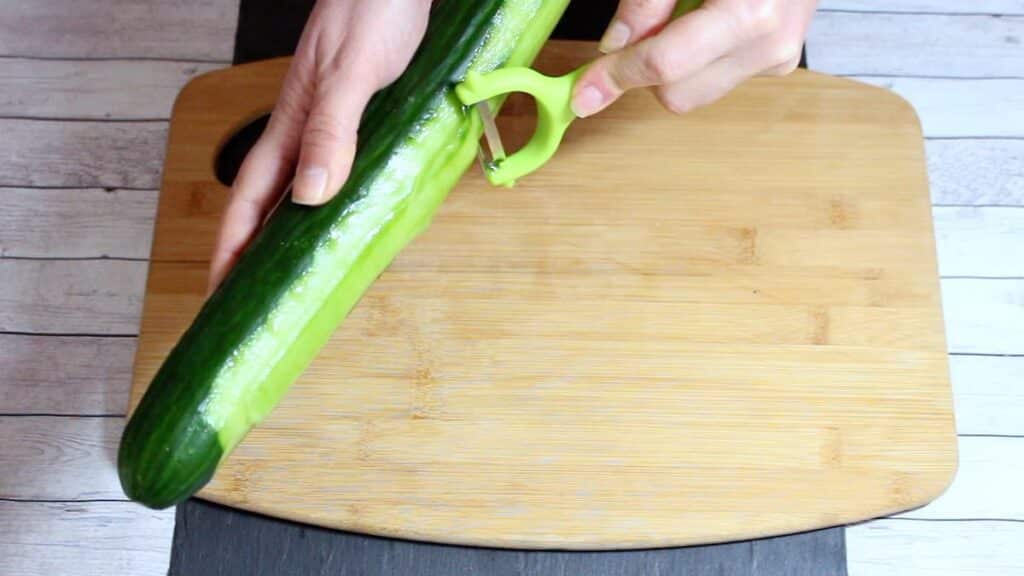 Healthiest Sushi Rolls slicing cucumber.