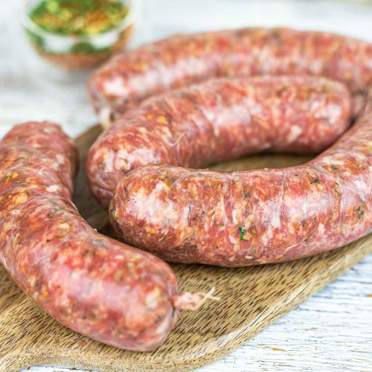 Low Carb Sausages prepared on the board for baking.
