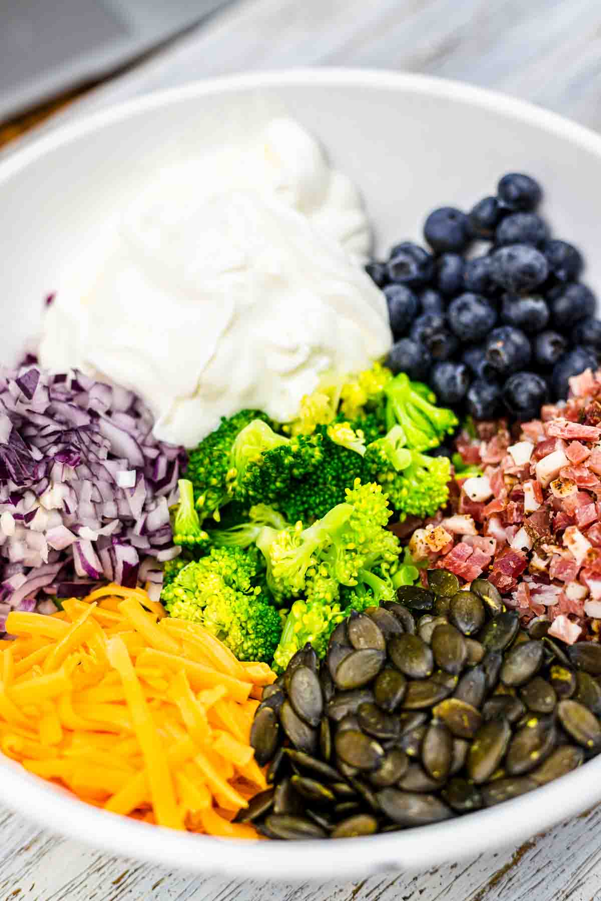 Broccoli Cold Salad ingredients in a bowl.