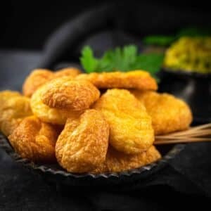 Keto Cheese Puffs Air Fryer inside a dark plate.