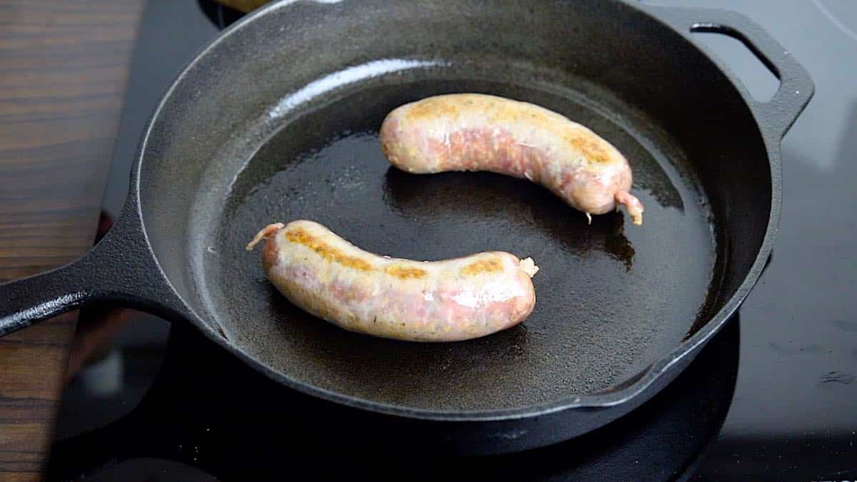 Oven Baked Sausage grilling in a cast iron.