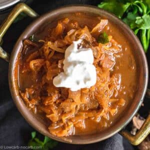 keto sauerkraut soup with sausage in a bowl.