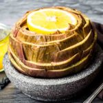 Steamed artichoke with lemon.