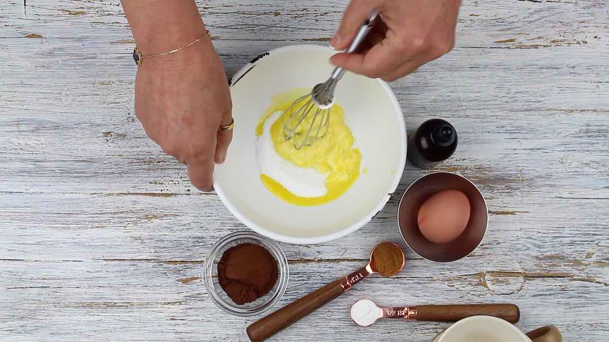 Chocolate Microwave Mug Cake mixing butter with sweetener.