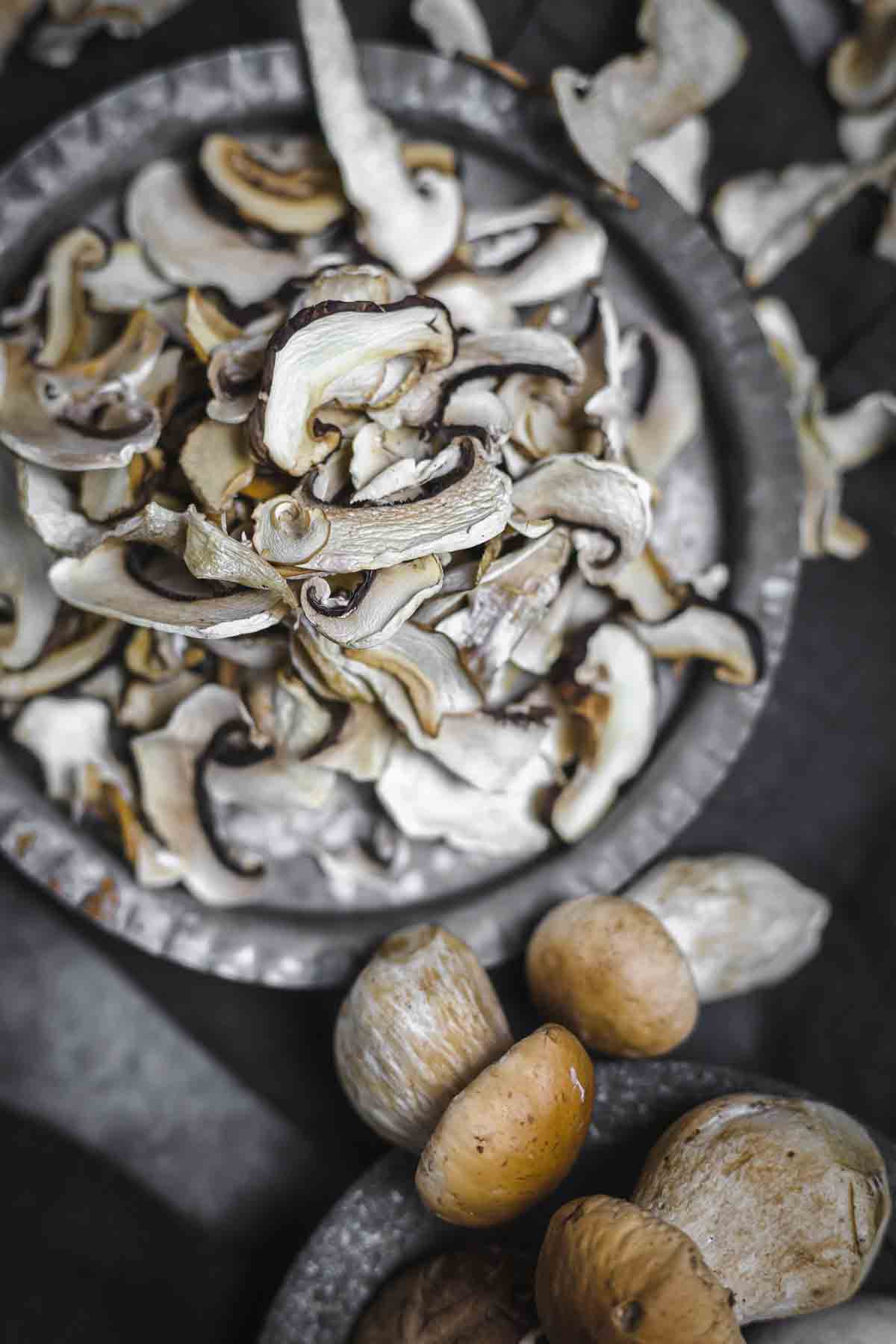 Dried slices of mushrooms in a gray tray.