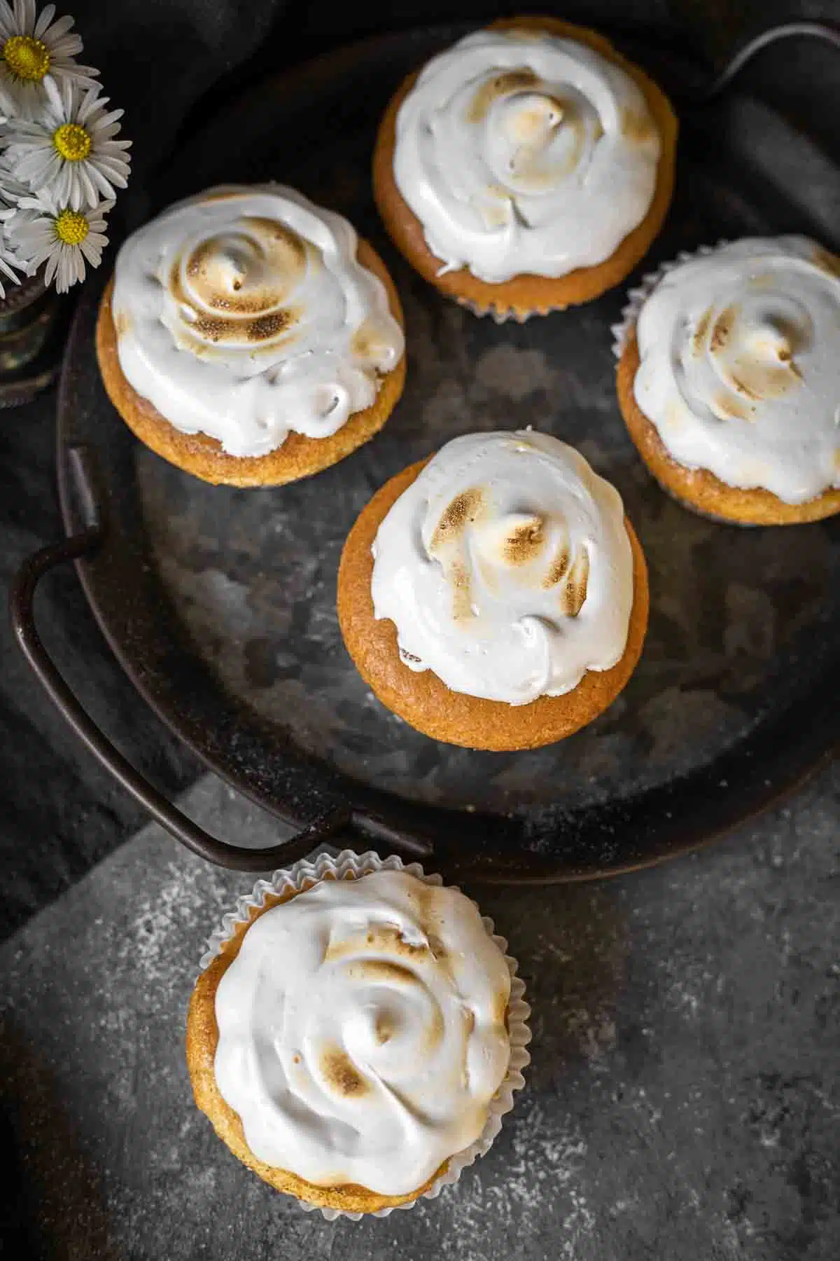 Cupcakes with almond Flour on a dark tray.