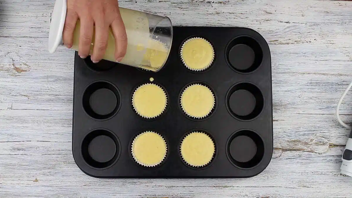 Homemade Cupcakes pouring into the muffin tin.