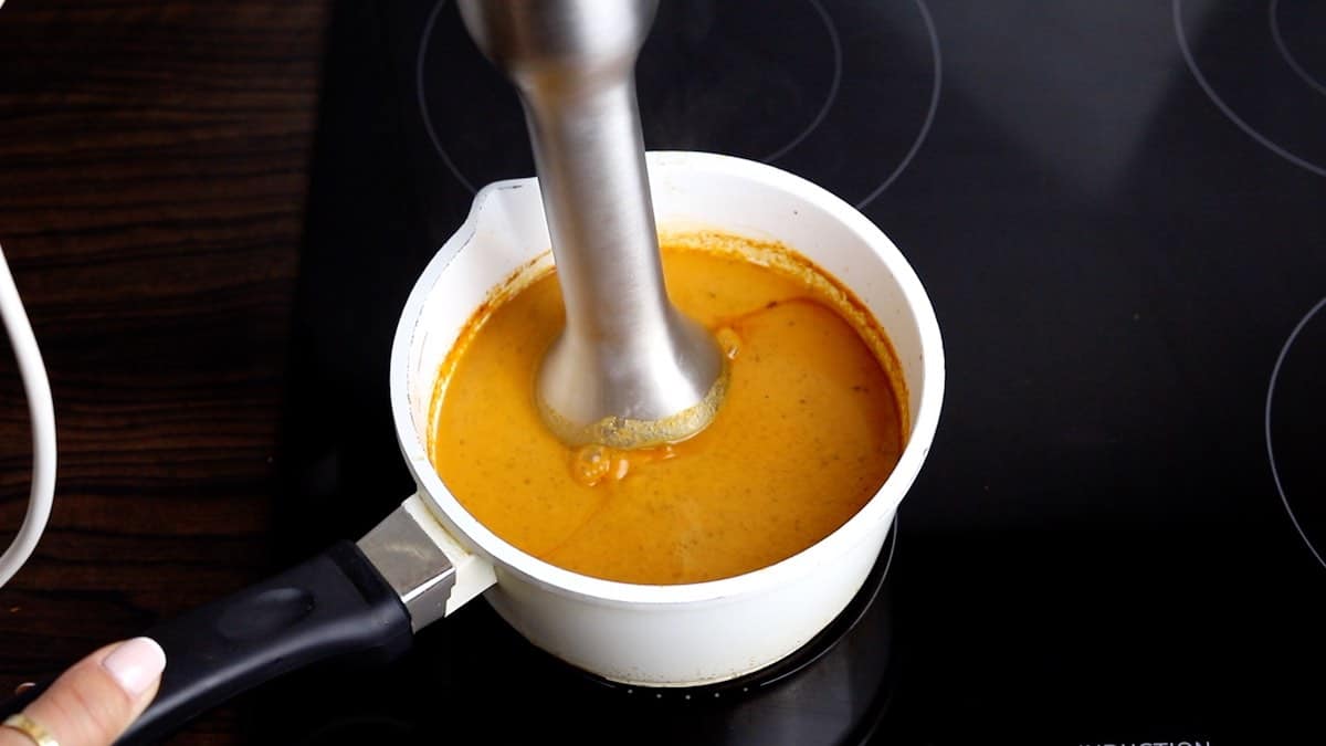 Homemade enchilada sauce mixing to smooth.