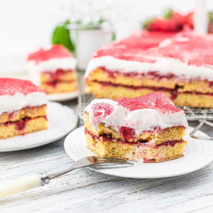 Strawberry vanilla cake served with fork.