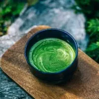 Bowl of matcha tea in the forest.