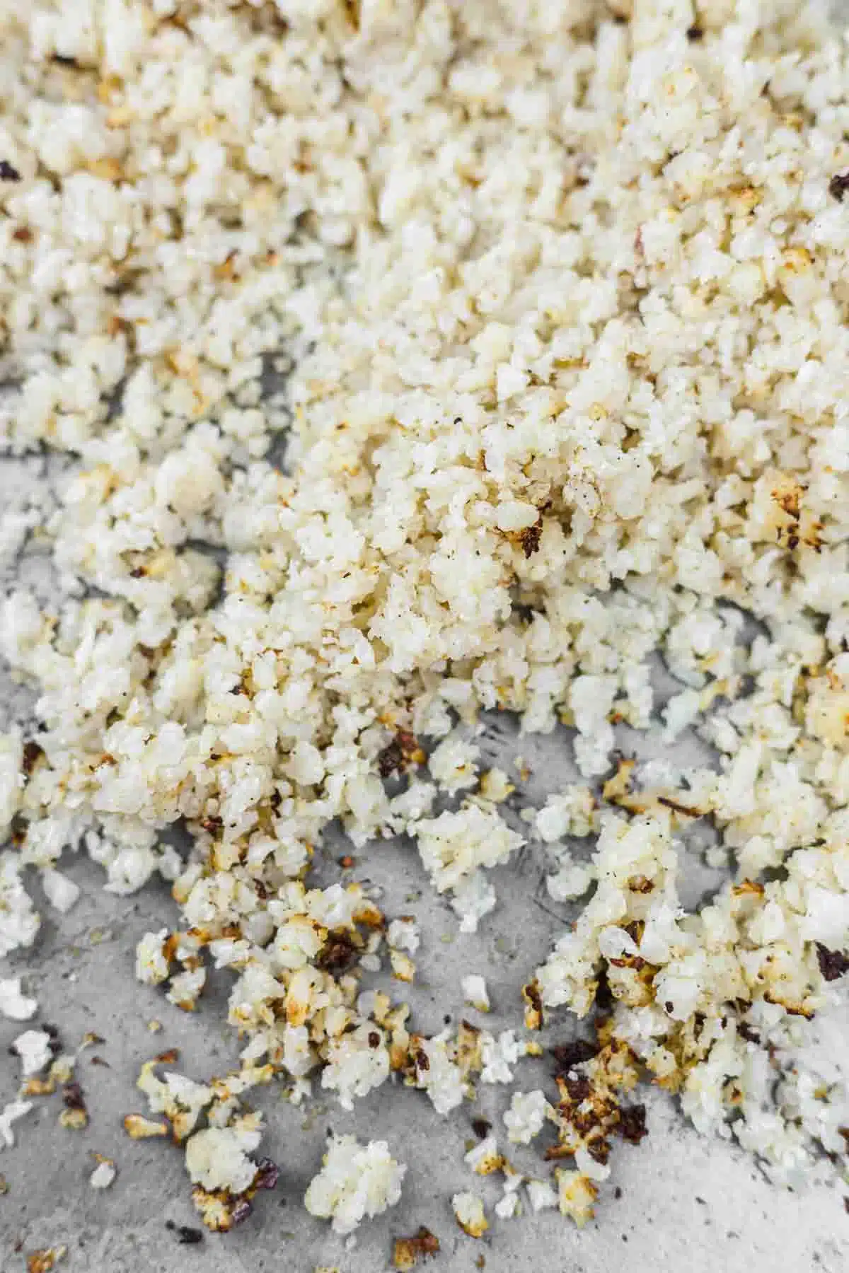 How To Season Cauliflower Rice on a baking tray.