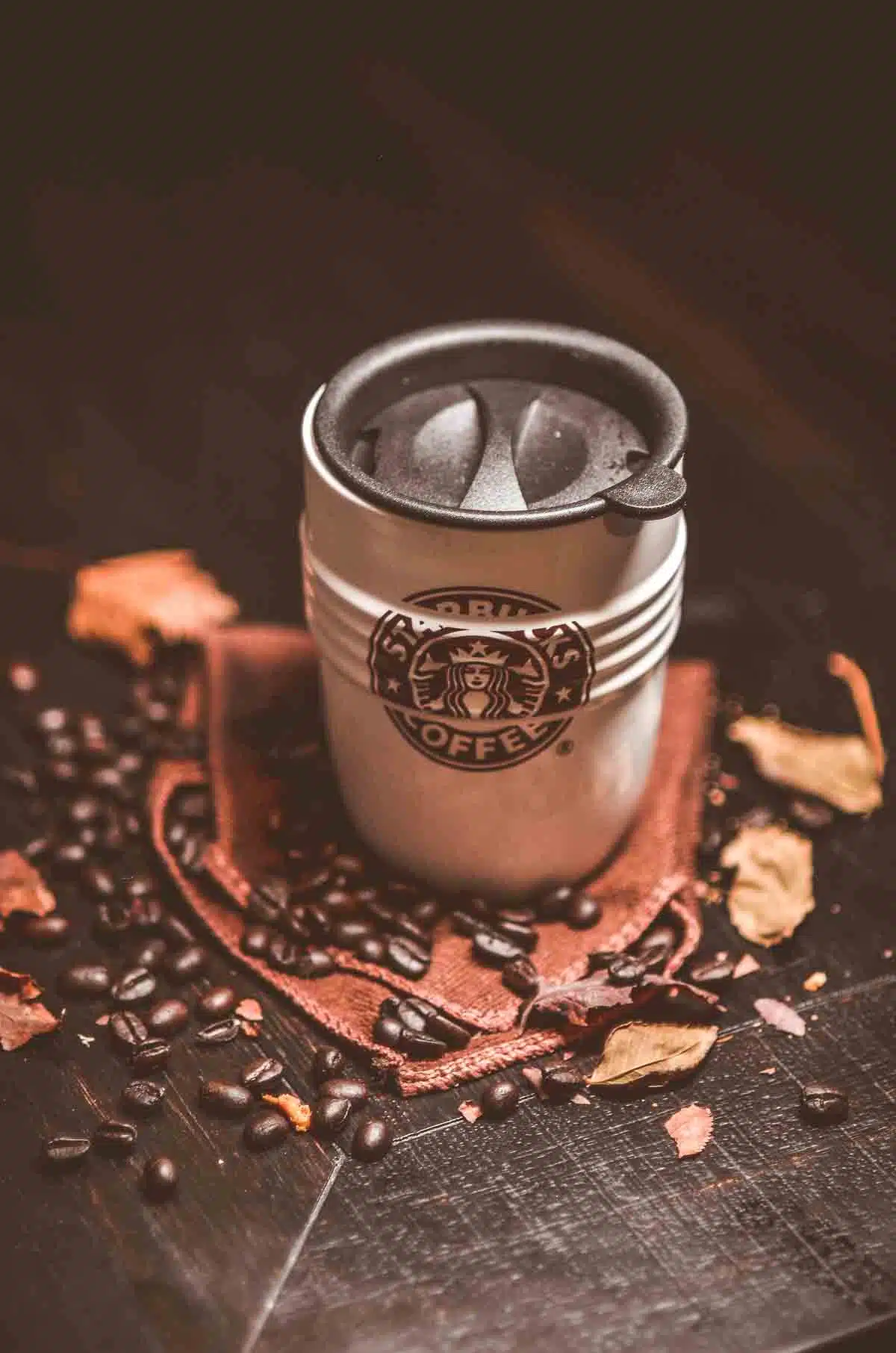 Starbucks Coffee Mug with fresh coffee beans.