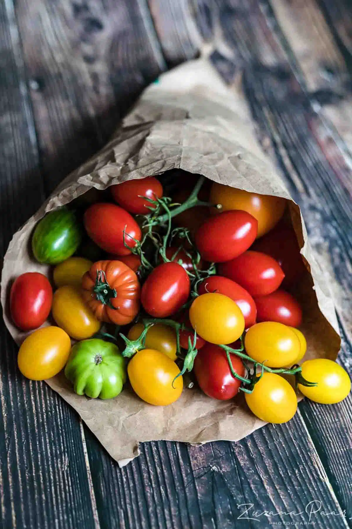 Fresh tomatoes in a paper bag.