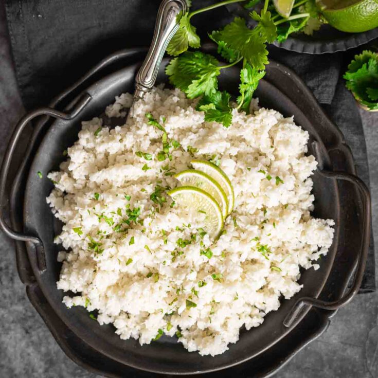 Cauliflower Coconut Rice served with lime slices.