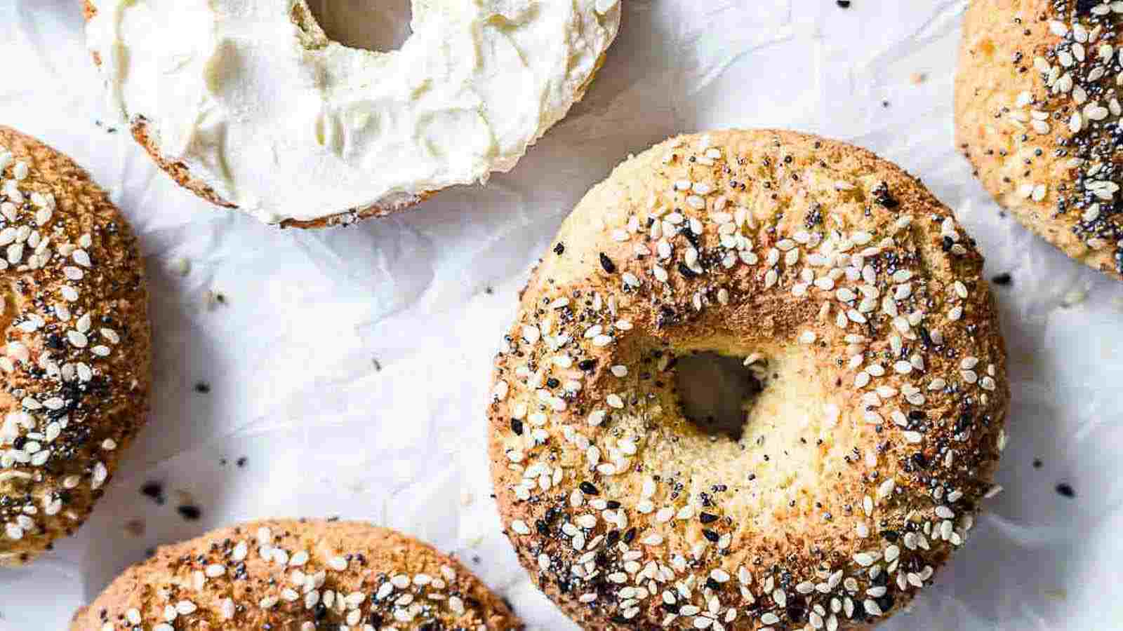 Bagels on a parchment paper with cream cheese.