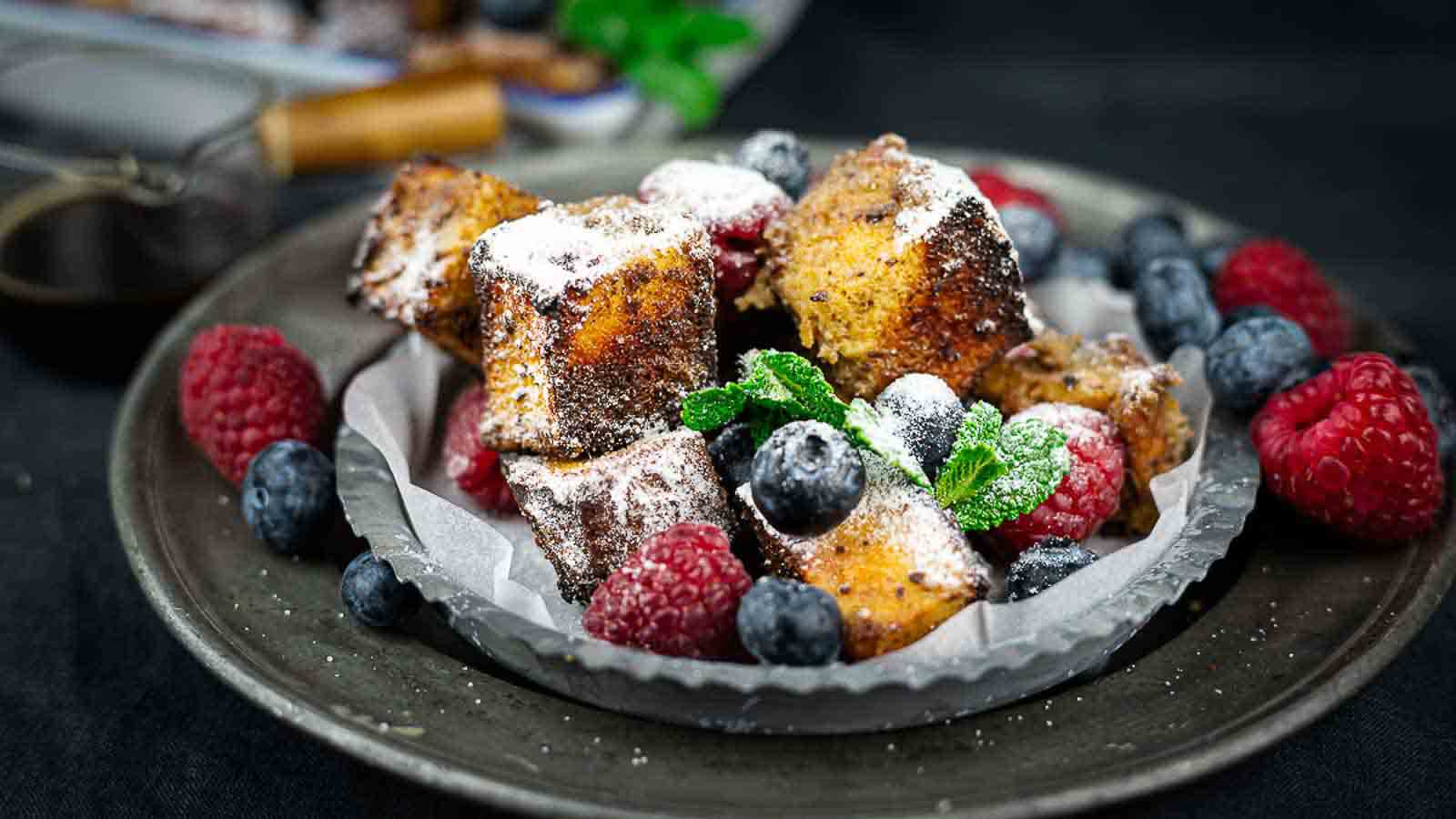 French toast with berries and powdered sugar.