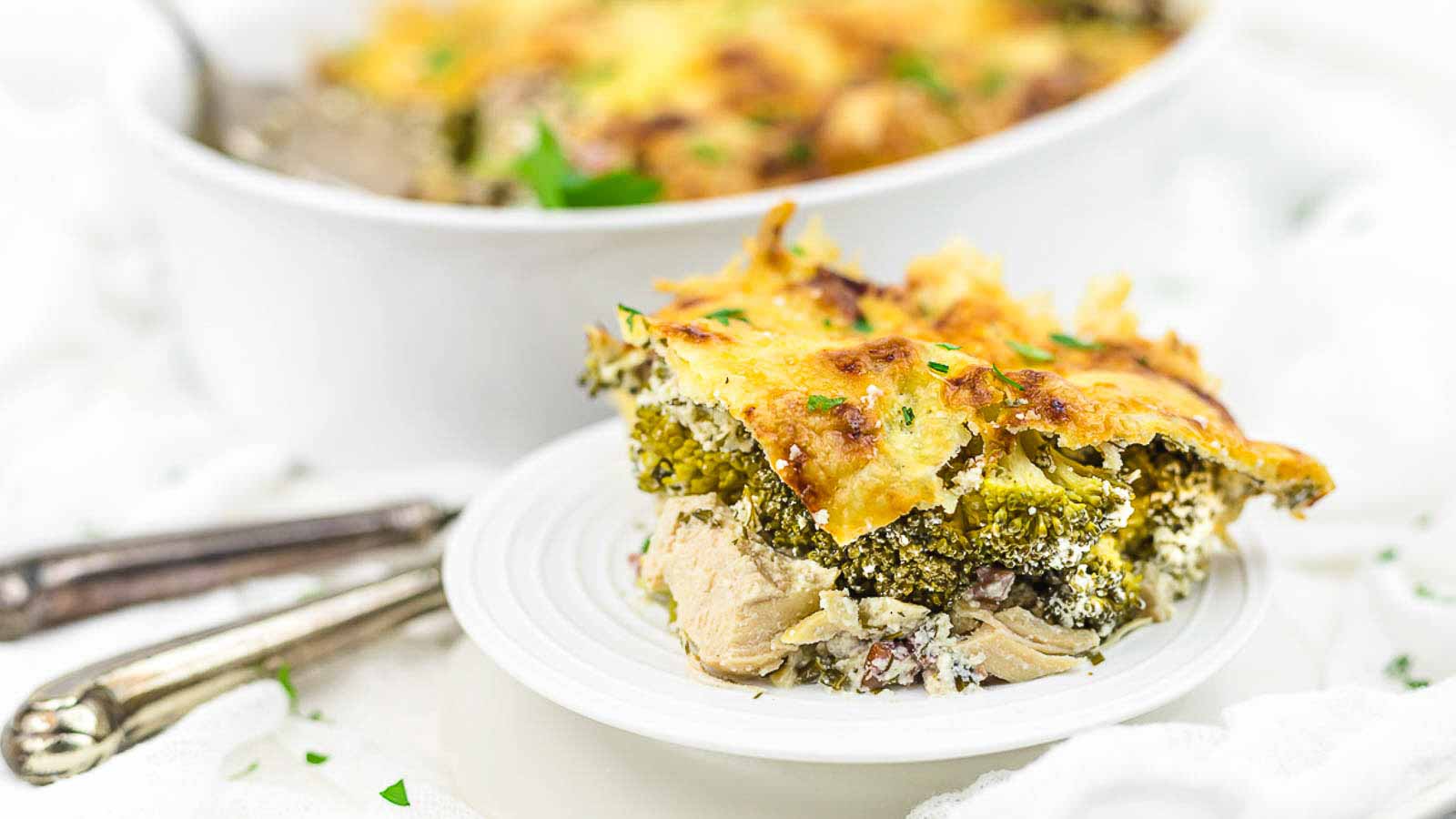 Chicken and broccoli casserole on a white plate.