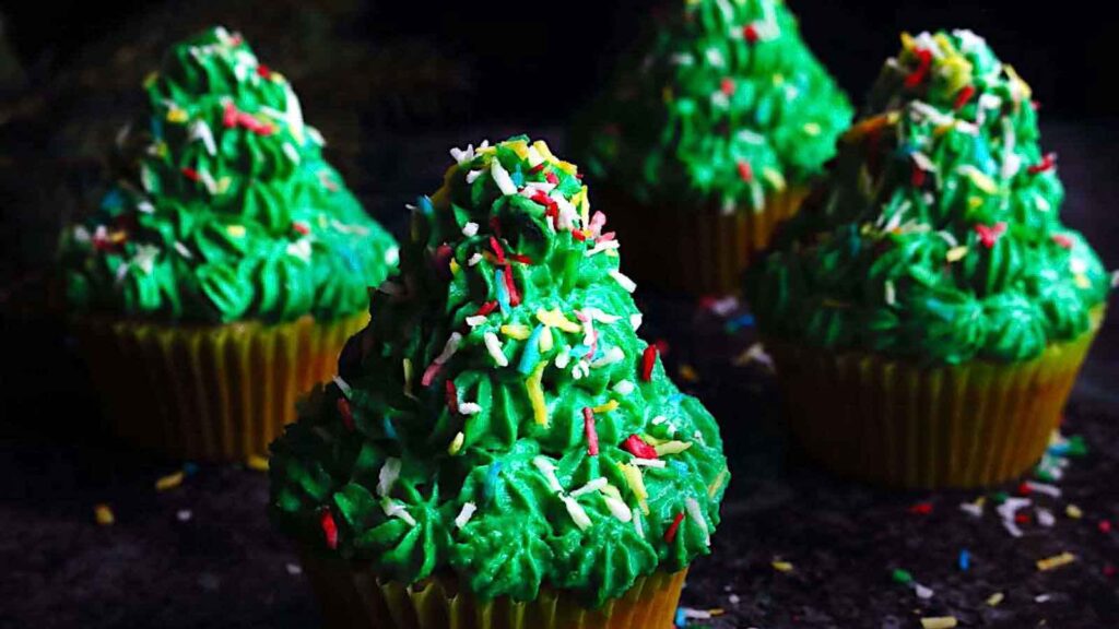 Christmas tree cupcakes with sprinkles.