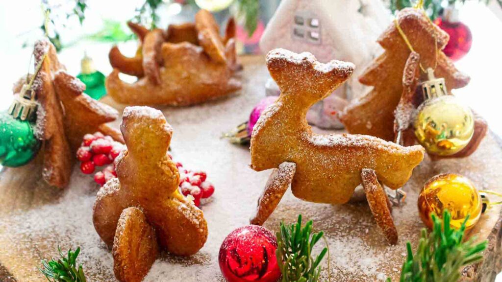 Gingerbread reindeer cookies on a wooden board.