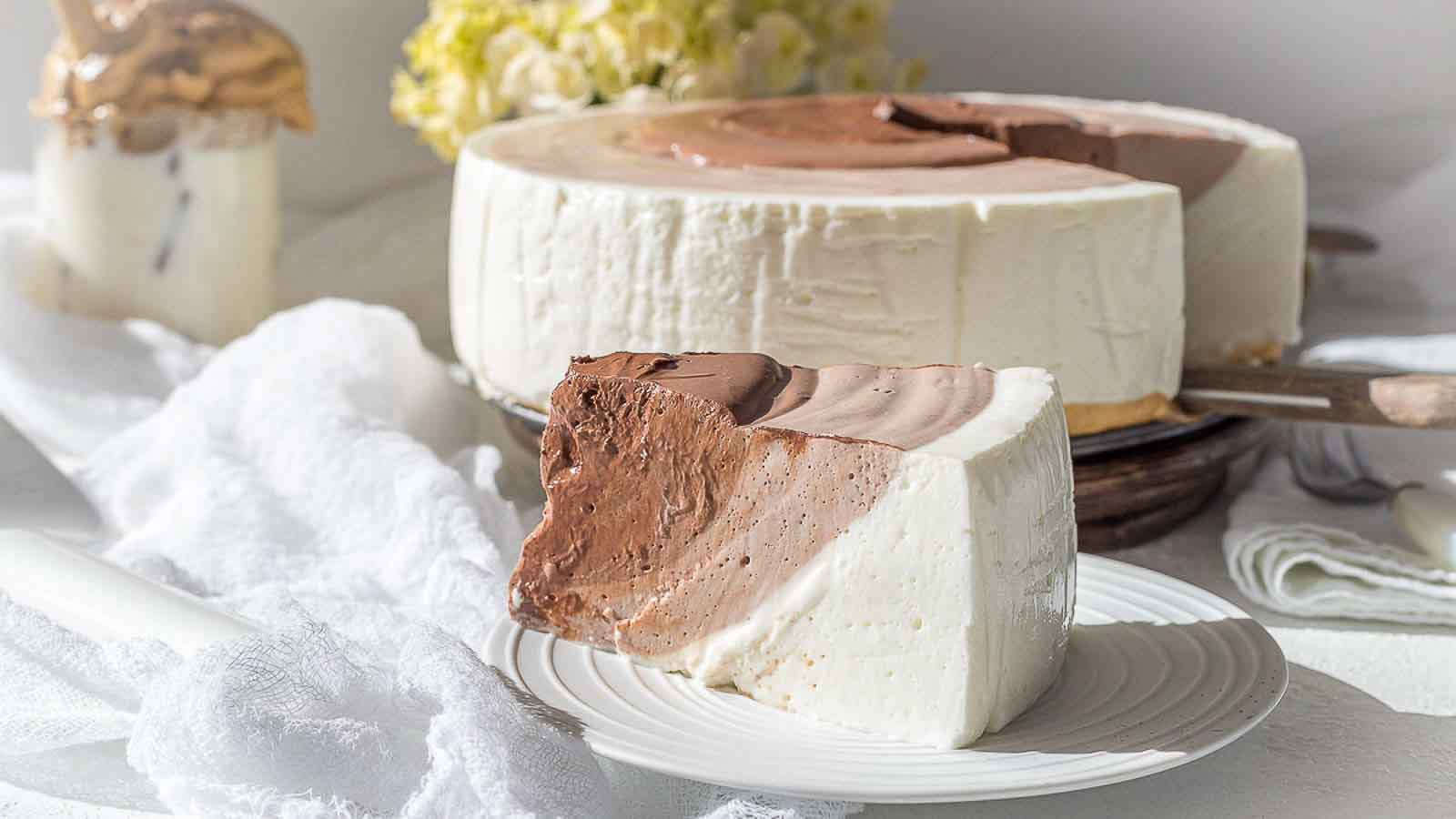 Yogurt Chocolate Ripple Keto Cheesecake piece on a white plate.