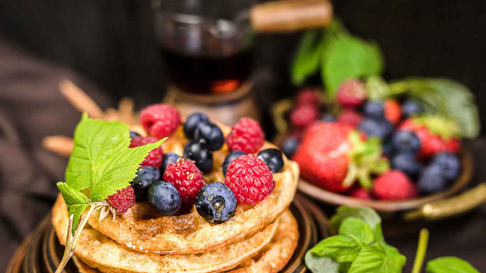 Chaffles on a plate with berries.