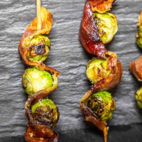 Brussels sprouts on skewers with bacon.