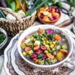 A bowl of soup with vegetables in it.